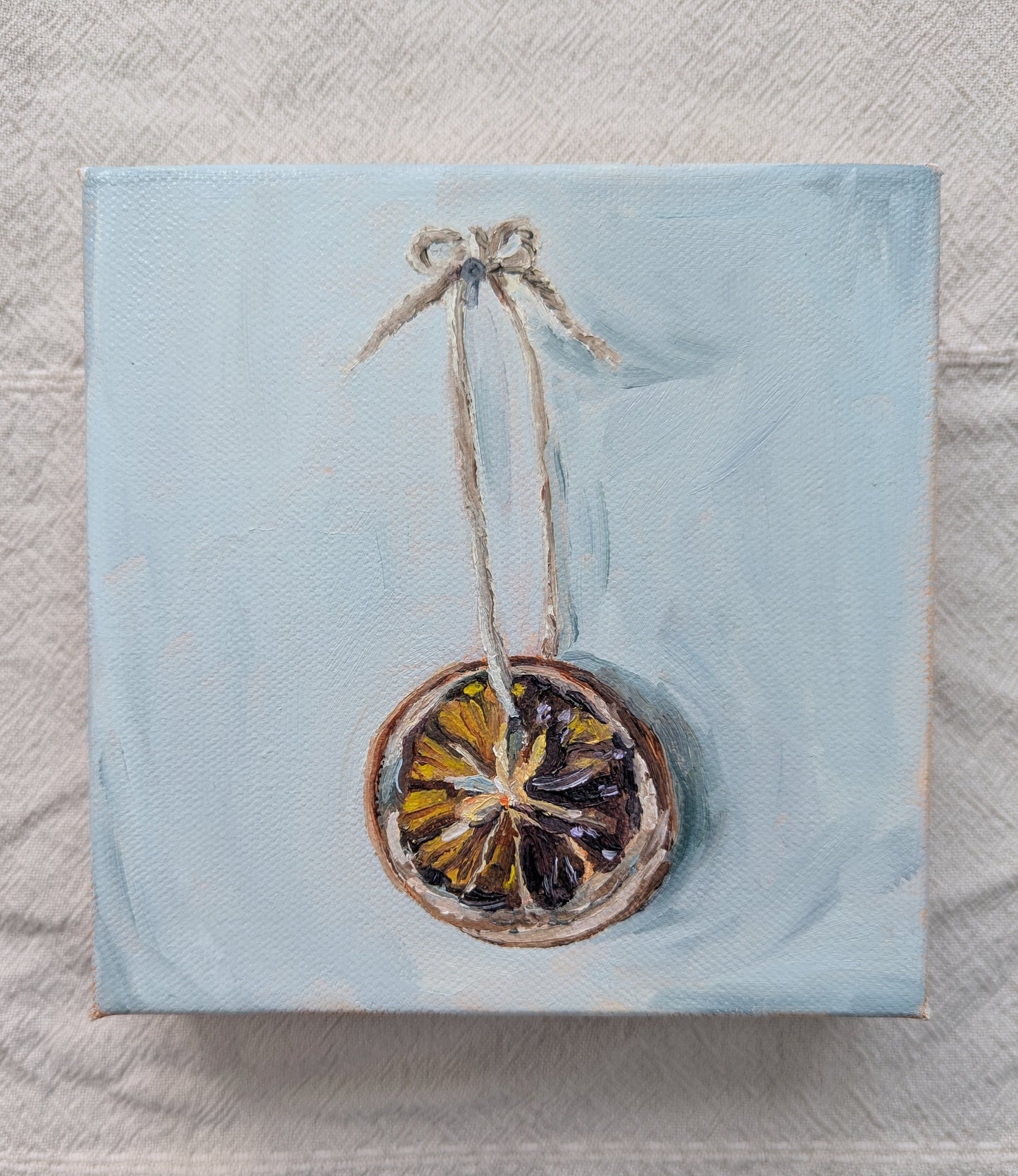 Original oil painting of vibrant orange slice, 6x6 inches on stretched canvas by Emily Langer
