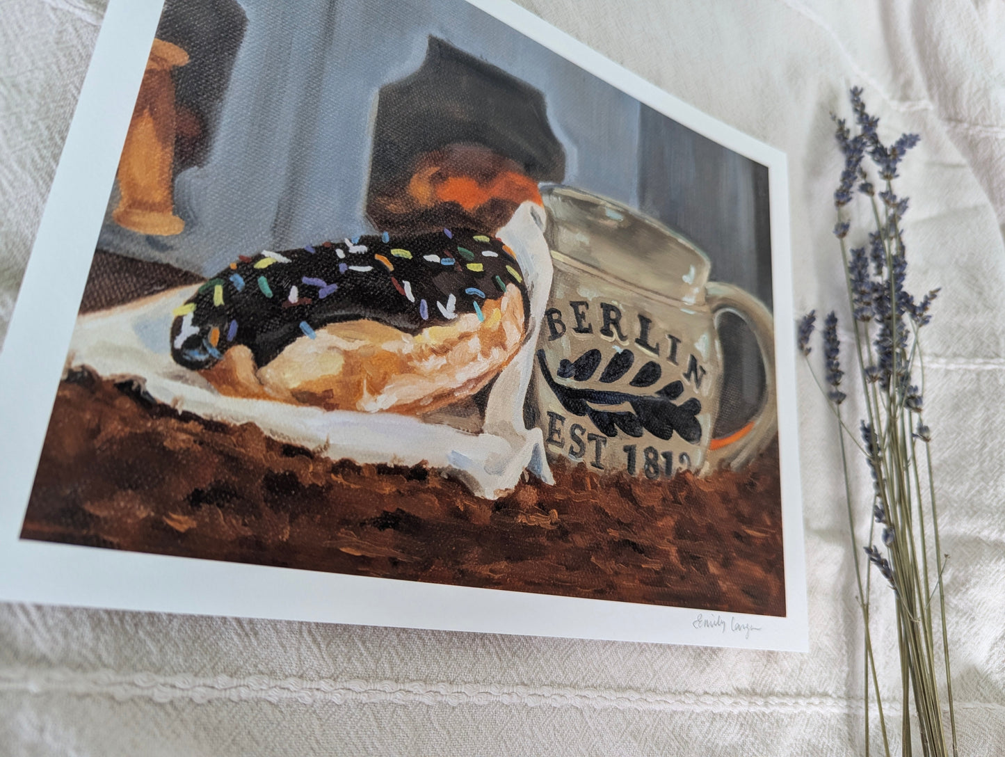 Framed artwork of a donut and coffee on a textured surface